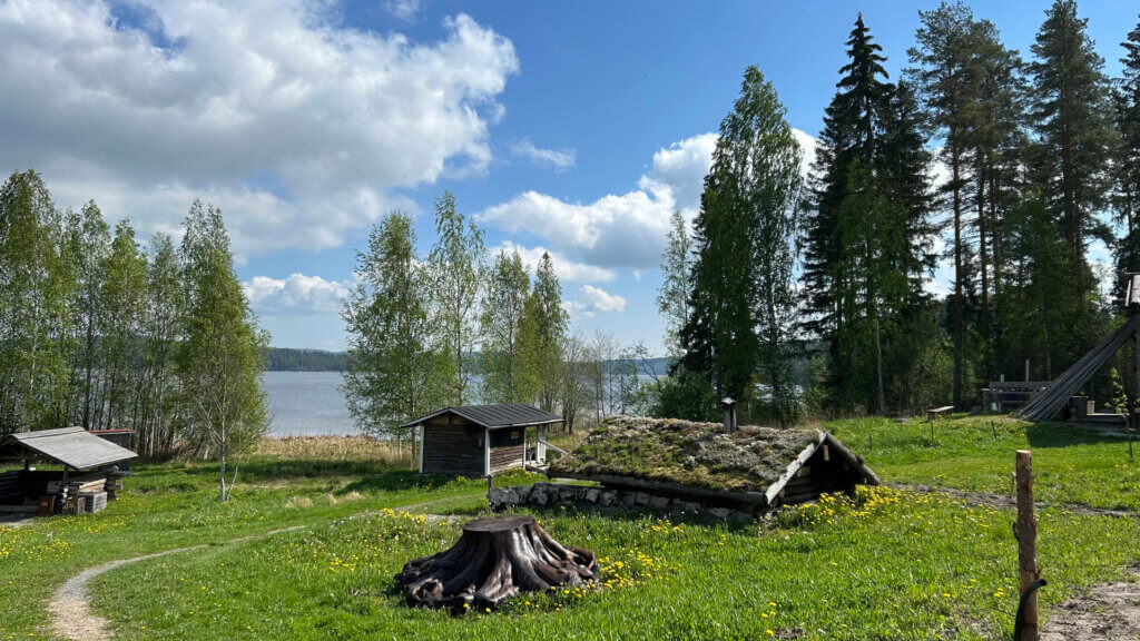 Kesäkuva Jämsän Saunakylästä. Taustalla Päijänne, etualalla savusaunoja.